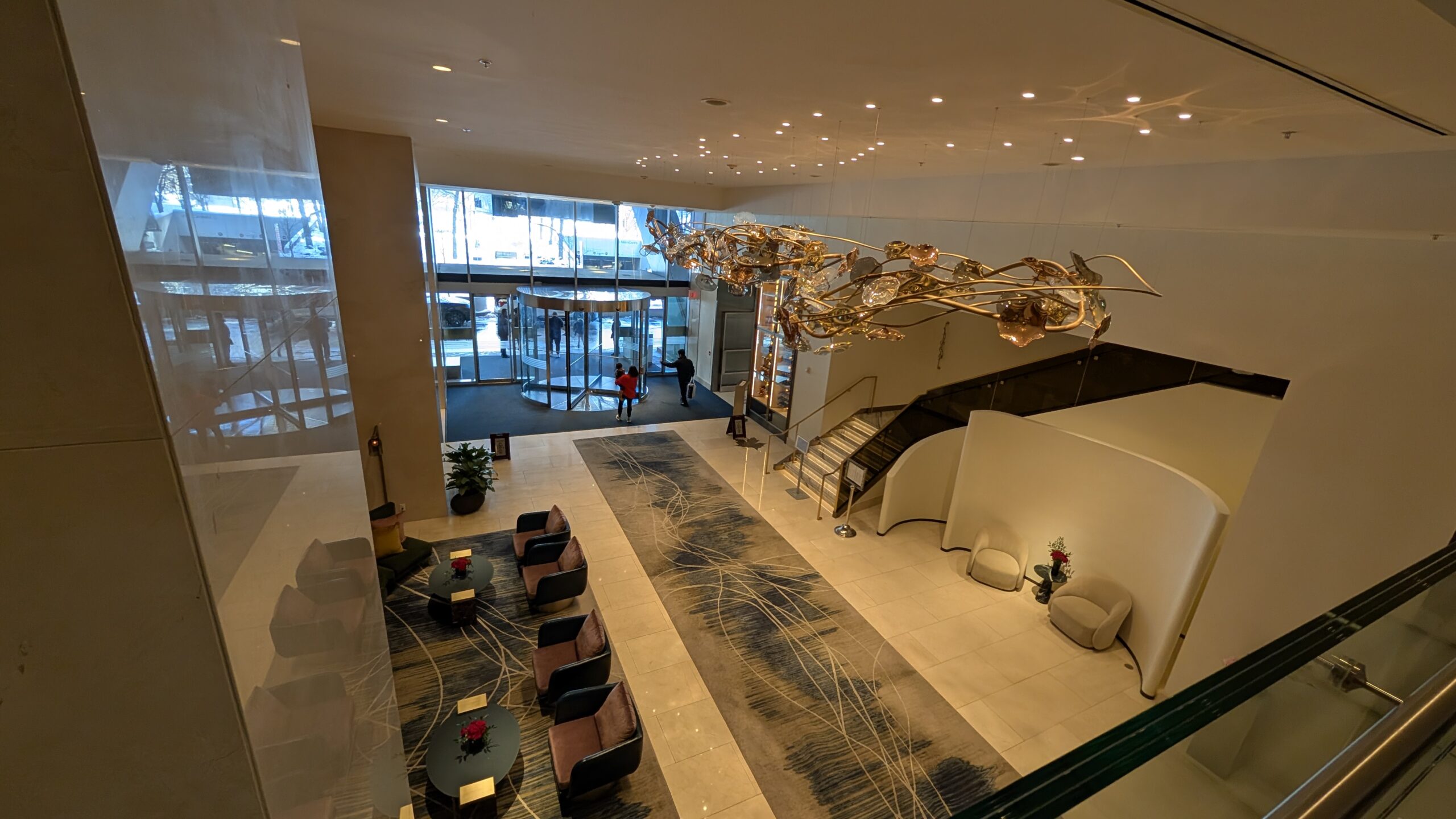 View of the Ritz-Carlton Toronto lobby from the second floor, polished marble floors, and luxurious seating areas below.